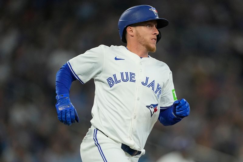 Jun 5, 2025; Toronto, Ontario, CAN; Toronto Blue Jays center fielder Myles Straw (3) runs to first base on his two run double against the Philadelphia Phillies during the third inning at Rogers Centre. Mandatory Credit: John E. Sokolowski-Imagn Images