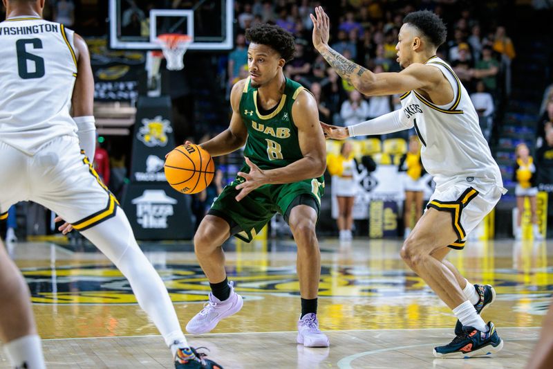 Feb 27, 2025; Wichita, Kansas, USA; UAB Blazers guard Efrem Johnson (8) sets the play around Wichita State Shockers guard Xavier Bell (1) during the first half at Charles Koch Arena. Mandatory Credit: William Purnell-Imagn Images