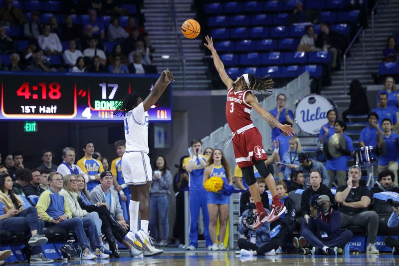 Jan 3, 2024; Los Angeles, California, USA; UCLA guard Will McClendon (4) attempts a three point shot as Stanford Cardinal guard Kanaan Carlyle (3) defends during the first half at Pauley Pavilion presented by Wescom. Mandatory Credit: Yannick Peterhans-USA TODAY Sports