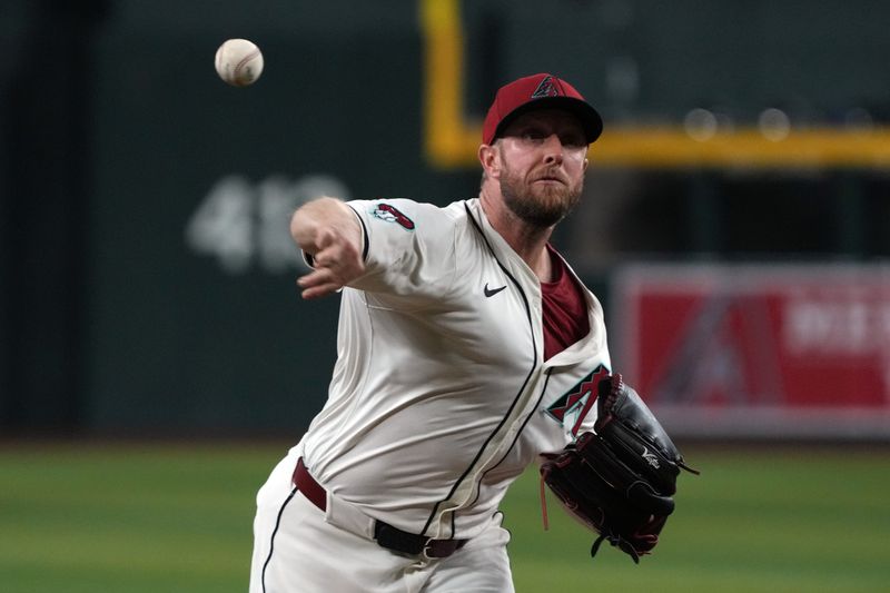 Jun 9, 2025; Phoenix, Arizona, USA; Arizona Diamondbacks pitcher Merrill Kelly (29) throws against the Seattle Mariners in the first inning at Chase Field. Mandatory Credit: Rick Scuteri-Imagn Images