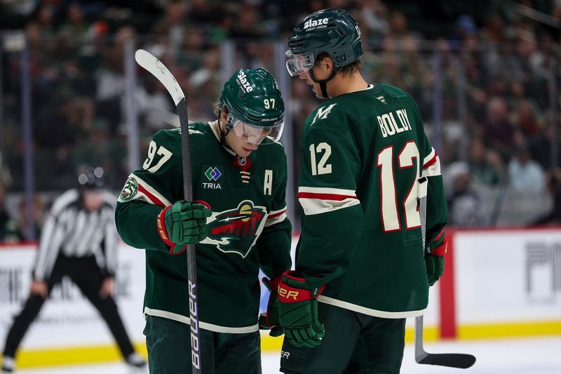 Sep 30, 2025; Saint Paul, Minnesota, USA; Minnesota Wild forward Matt Boldy (12) talks to forward Kirill Kaprizov (97) during the second period against the Winnipeg Jets at Grand Casino Arena. Mandatory Credit: Matt Krohn-Imagn Images