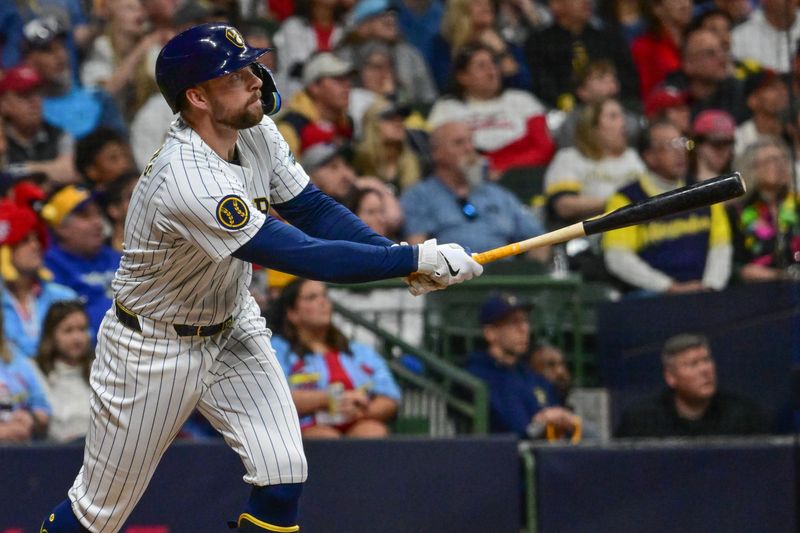 May 11, 2024; Milwaukee, Wisconsin, USA; Milwaukee Brewers first baseman Rhys Hoskins (12) watches after hitting a three-run home run against the St. Louis Cardinals in the seventh inning at American Family Field. Mandatory Credit: Benny Sieu-USA TODAY Sports