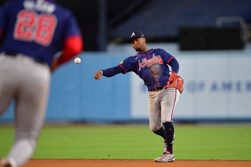 May 4, 2024; Los Angeles, California, USA; Atlanta Braves second baseman Ozzie Albies (1) throws to first baseman Matt Olson (28) for the out against Los Angeles Dodgers center fielder James Outman (33) during the eighth inning at Dodger Stadium. Mandatory Credit: Gary A. Vasquez-USA TODAY Sports