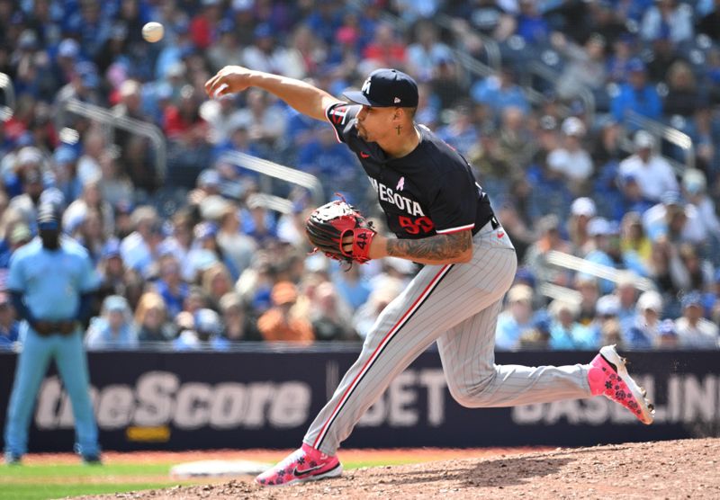 May 12, 2024; Toronto, Ontario, CAN;  Minnesota Twins relief pitcher Jhoan Duran (59) delivers a pitch against the Toronto Blue Jays in the ninth inning at Rogers Centre. Mandatory Credit: Dan Hamilton-USA TODAY Sports