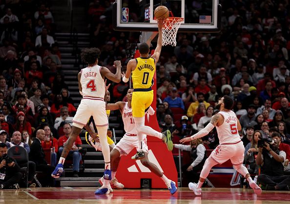 HOUSTON, TEXAS - DECEMBER 26: Tyrese Haliburton #0 of the Indiana Pacers shoots the ball in front of Jabari Smith Jr. #10 of the Houston Rockets and Jalen Green #4 in the second half at Toyota Center on December 26, 2023 in Houston, Texas.  NOTE TO USER: User expressly acknowledges and agrees that, by downloading and or using this photograph, User is consenting to the terms and conditions of the Getty Images License Agreement. (Photo by Tim Warner/Getty Images)