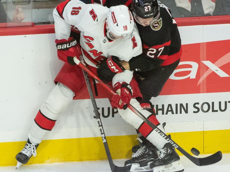 Dec 12, 2023; Ottawa, Ontario, CAN; Carolina Hurricanes center Jack Drury (18) battles with Ottawa Senators left wing Parker Kelly (27) in the third period at the Canadian Tire Centre. Mandatory Credit: Marc DesRosiers-USA TODAY Sports.