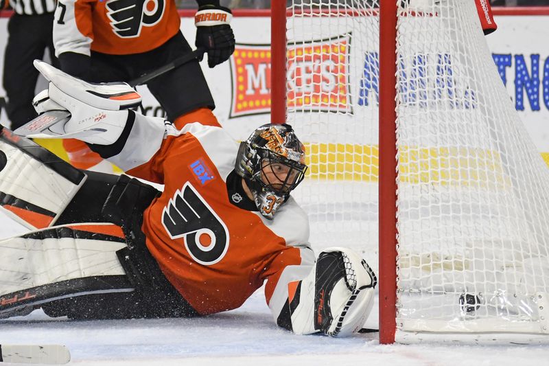 Nov 11, 2024; Philadelphia, Pennsylvania, USA; Philadelphia Flyers goaltender Samuel Ersson (33) looks at the puck after allowing goal by San Jose Sharks defenseman Jack Thompson (26) (not pictured) during the second period at Wells Fargo Center. Mandatory Credit: Eric Hartline-Imagn Images