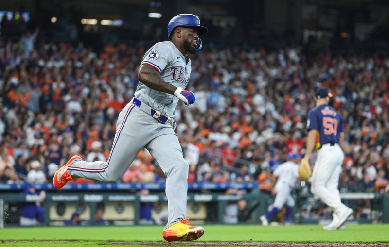 Apr 14, 2024; Houston, Texas, USA; Texas Rangers right fielder Adolis Garcia (53) hits a single during the eighth inning against the Houston Astros at Minute Maid Park. Mandatory Credit: Troy Taormina-USA TODAY Sports