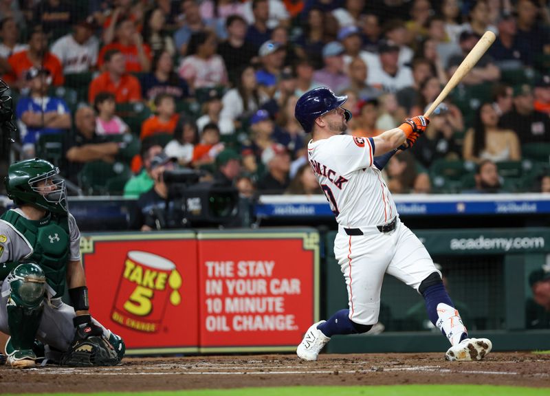 May 27, 2025; Houston, Texas, USA; Houston Astros left fielder Chas McCormick (20) hits a RBI double against the Athletics in the second inning at Daikin Park. Mandatory Credit: Thomas Shea-Imagn Images
