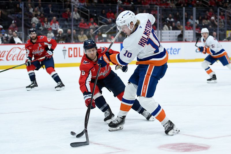 Feb 2, 2026; Washington, District of Columbia, USA; New York Islanders right wing Simon Holmstrom (10) shoots the puck defended by Washington Capitals defenseman Jakob Chychrun (6) during the third period at Capital One Arena. Mandatory Credit: Hannah Foslien-Imagn Images