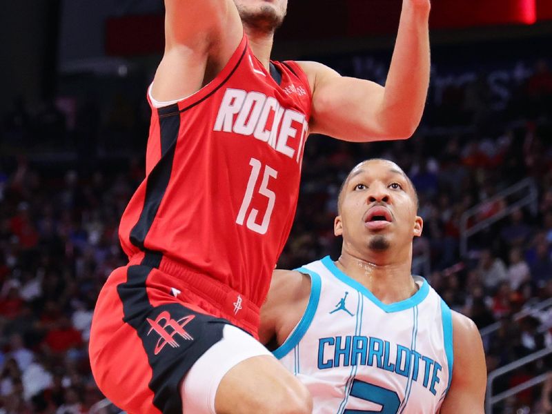 HOUSTON, TEXAS - OCTOBER 23: Reed Sheppard #15 of the Houston Rockets goes up against Grant Williams #2 of the Charlotte Hornets during the second half at Toyota Center on October 23, 2024 in Houston, Texas.  NOTE TO USER: User expressly acknowledges and agrees that, by downloading and or using this photograph, User is consenting to the terms and conditions of the Getty Images License Agreement. (Photo by Alex Slitz/Getty Images)