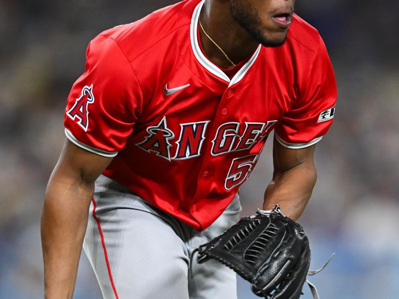 Jun 22, 2024; Los Angeles, California, USA; Los Angeles Angels pitcher Roansy Contreras (57) catches a short ball against the Los Angeles Dodgers during the eighth inning at Dodger Stadium. Mandatory Credit: Jonathan Hui-USA TODAY Sports