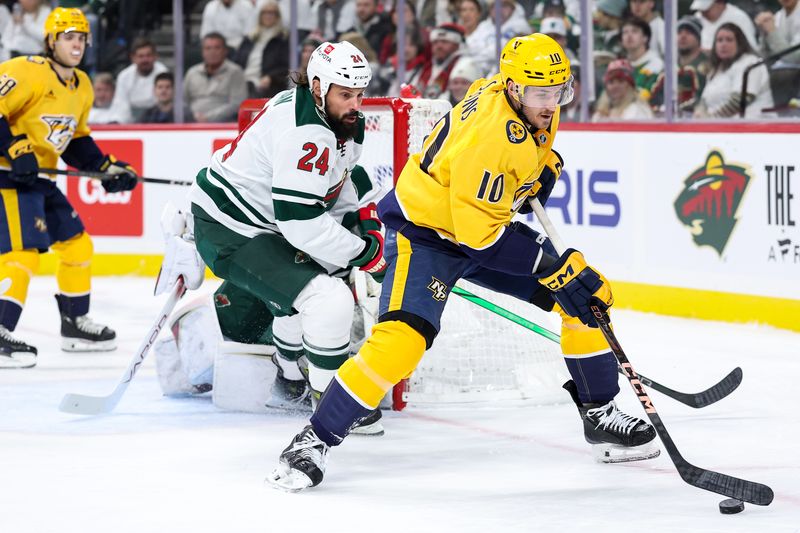 Nov 30, 2024; Saint Paul, Minnesota, USA; Nashville Predators center Colton Sissons (10) skates with the puck as Minnesota Wild defenseman Zach Bogosian (24) defends during the first period at Xcel Energy Center. Mandatory Credit: Matt Krohn-Imagn Images