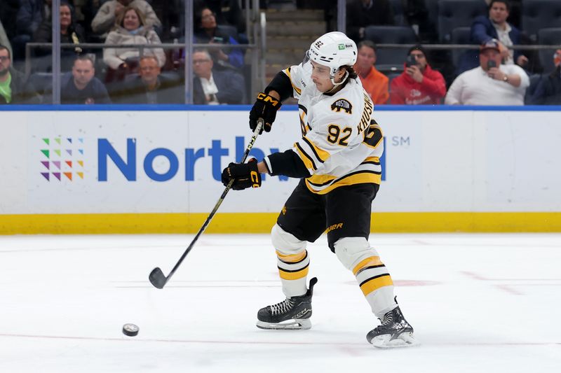 Nov 4, 2025; Elmont, New York, USA; Boston Bruins center Marat Khusnutdinov (92) shoots against the New York Islanders during the shootout at UBS Arena. Mandatory Credit: Brad Penner-Imagn Images