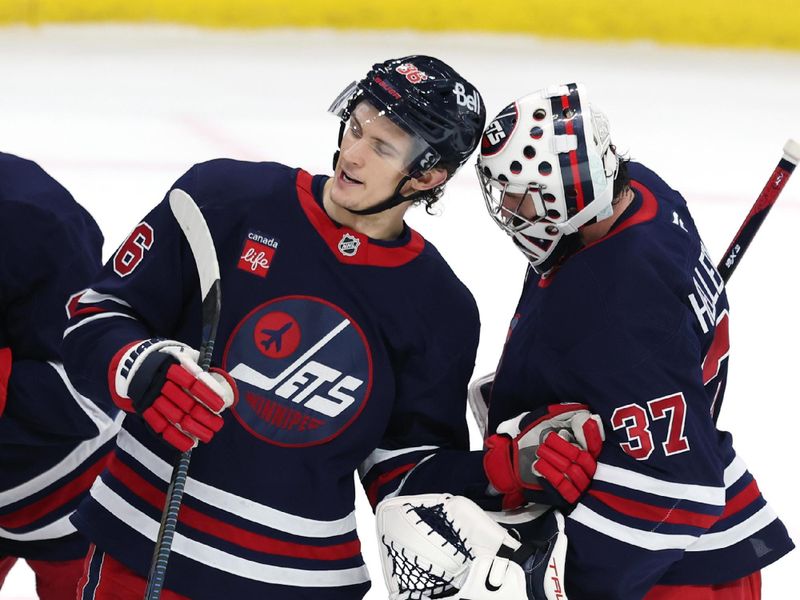 Jan 16, 2025; Winnipeg, Manitoba, CAN; Winnipeg Jets goaltender Connor Hellebuyck (37) and Winnipeg Jets center Morgan Barron (36) celebrate their victory over the Seattle Kraken at Canada Life Centre. Mandatory Credit: James Carey Lauder-Imagn Images