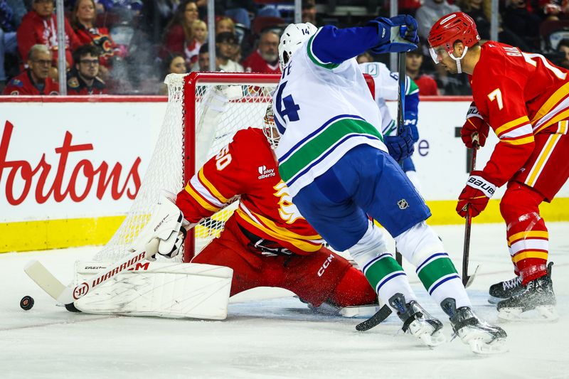 Oct 1, 2025; Calgary, Alberta, CAN; Calgary Flames goaltender Ivan Prosvetov (50) makes a save against the Vancouver Canucks during the first period at Scotiabank Saddledome. Mandatory Credit: Sergei Belski-Imagn Images