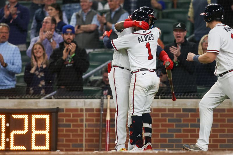 Apr 11, 2023; Atlanta, Georgia, USA; Atlanta Braves second baseman Ozzie Albies (1) hugs shortstop Orlando Arcia (11) after a home run against the Cincinnati Reds in the fourth inning at Truist Park. Mandatory Credit: Brett Davis-USA TODAY Sports
