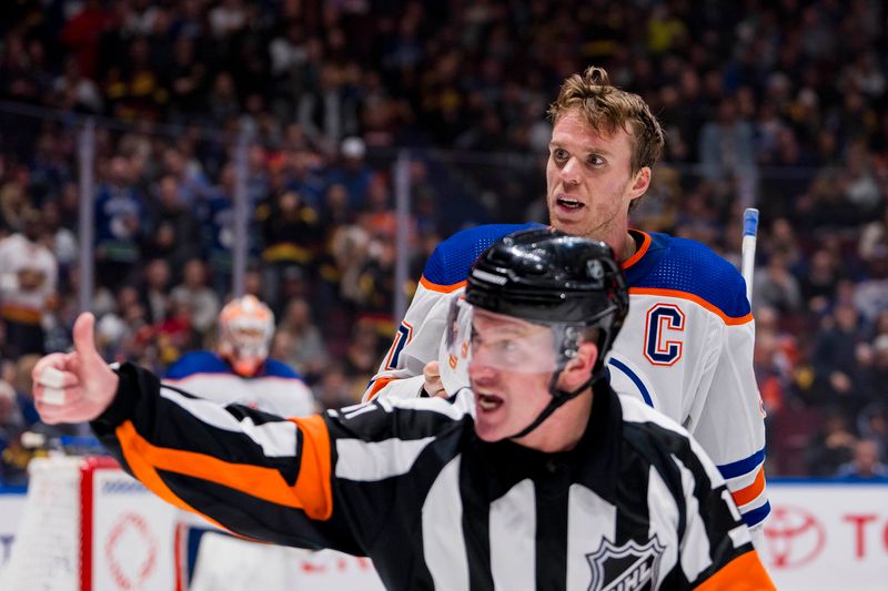 Nov 6, 2023; Vancouver, British Columbia, CAN; Edmonton Oilers forward Connor McDavid (97) reacts to referee Kelly Sutherland calling a penalty in a game against the Vancouver Canucks in the third period at Rogers Arena. Mandatory Credit: Bob Frid-USA TODAY Sports