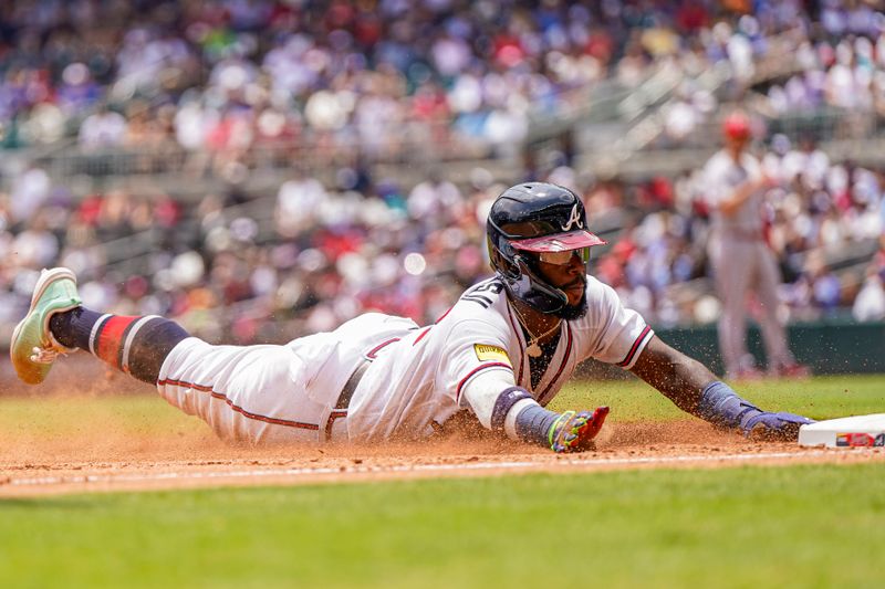 Aug 2, 2023; Cumberland, Georgia, USA; Atlanta Braves center fielder Michael Harris II (23) slides into third base against the Los Angeles Angels during the sixth inning at Truist Park. Mandatory Credit: Dale Zanine-USA TODAY Sports