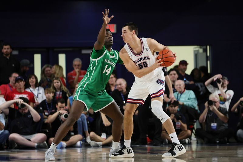 Jan 28, 2024; Boca Raton, Florida, USA; Florida Atlantic Owls center Vladislav Goldin (50) protects the basketball from North Texas Mean Green forward Moulaye Sissoko (14) during the first half at Eleanor R. Baldwin Arena. Mandatory Credit: Sam Navarro-USA TODAY Sports