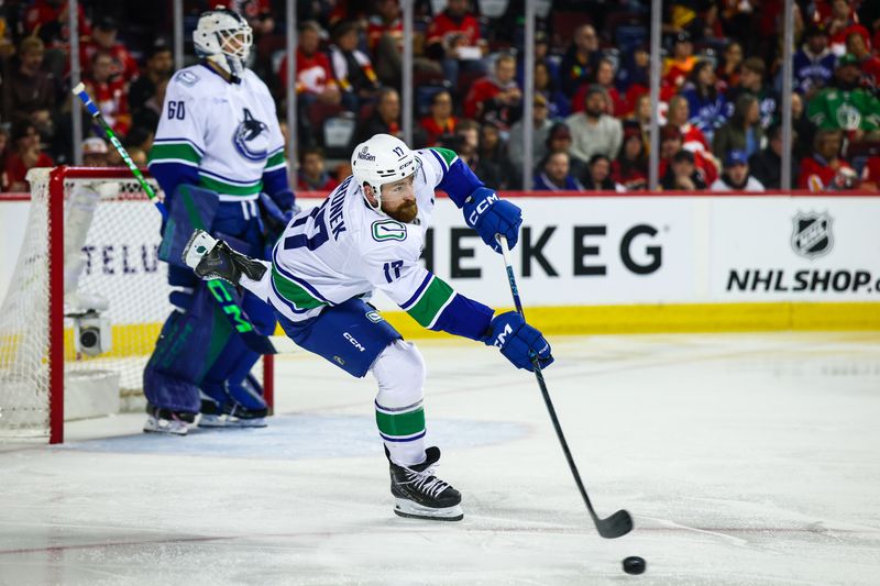 Mar 28, 2026; Calgary, Alberta, CAN; Vancouver Canucks defenseman Filip Hronek (17) passes the puck against the Calgary Flames during the second period at Scotiabank Saddledome. Mandatory Credit: Sergei Belski-Imagn Images Mar 28, 2026; Calgary, Alberta, CAN; Vancouver Canucks defenseman Filip Hronek (17) passes the puck against the Calgary Flames during the second period at Scotiabank Saddledome. Mandatory Credit: Sergei Belski-Imagn Images