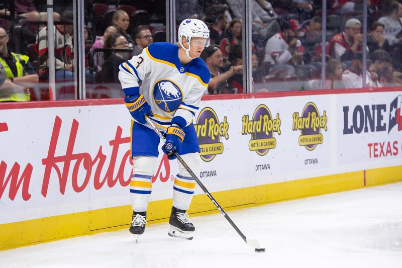 Sep 26, 2024; Ottawa, Ontario, CAN; Buffalo Sabres defenseman Jack Rathbone (3) controls the puck in the first period against the Ottawa Senators at the Canadian Tire Centre. Mandatory Credit: Marc DesRosiers-Imagn Images