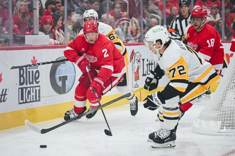 Oct 10, 2024; Detroit, Michigan, USA; Detroit Red Wings defenseman Olli Maatta (2) and Pittsburgh Penguins left wing Anthony Beauvillier (72) battle for the puck during the first period at Little Caesars Arena. Mandatory Credit: Tim Fuller-Imagn Images