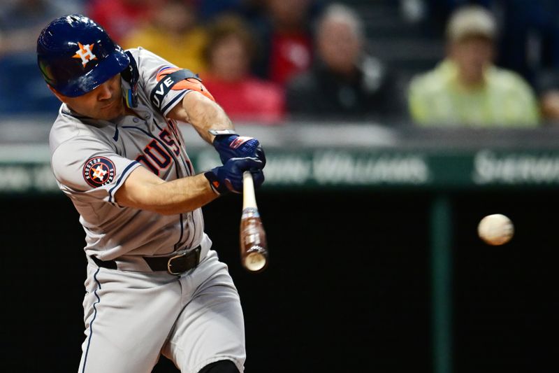 Sep 27, 2024; Cleveland, Ohio, USA; Houston Astros second baseman Jose Altuve (27) hits a double during the first inning against the Cleveland Guardians at Progressive Field. Mandatory Credit: Ken Blaze-Imagn Images