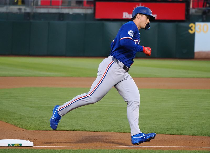 Sep 25, 2024; Oakland, California, USA; Texas Rangers center fielder Wyatt Langford (36) rounds third base on a two-run home run against the Oakland Athletics during the first inning at Oakland-Alameda County Coliseum. Mandatory Credit: Kelley L Cox-Imagn Images