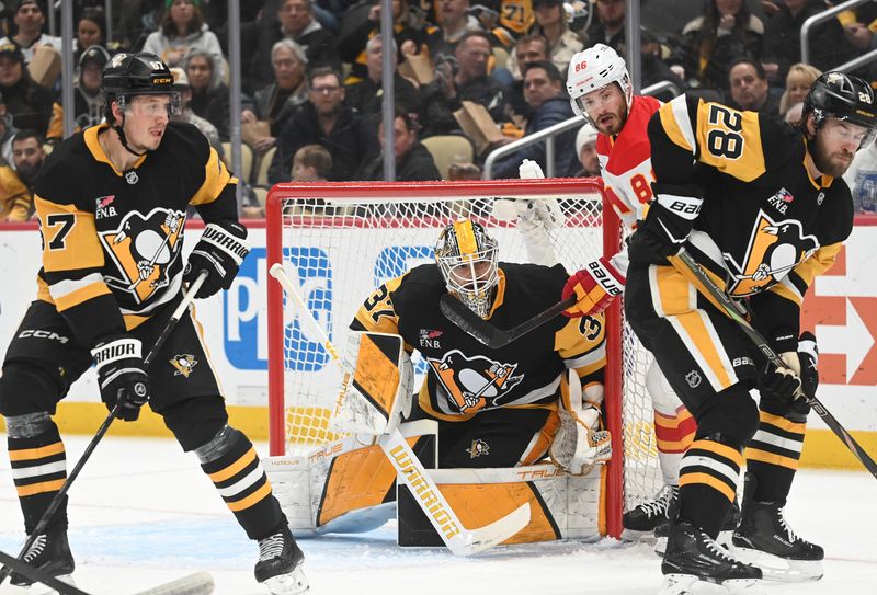 Jan 10, 2026; Pittsburgh, Pennsylvania, USA;  Pittsburgh Penguins goalie Arturs Silovs (37) protects the net as Calgary Flames left wing Joel Farabee (86) applies pressure near Rickard Rakell (67) and Parker Wotherspoon (28) during the second period at PPG Paints Arena. Mandatory Credit: Philip G. Pavely-Imagn Images