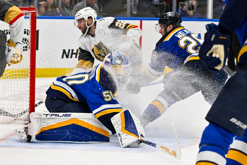 Mar 25, 2024; St. Louis, Missouri, USA;  St. Louis Blues goaltender Jordan Binnington (50) and left wing Nathan Walker (26) defend the net against Vegas Golden Knights right wing Michael Amadio (22) during the first period at Enterprise Center. Mandatory Credit: Jeff Curry-USA TODAY Sports