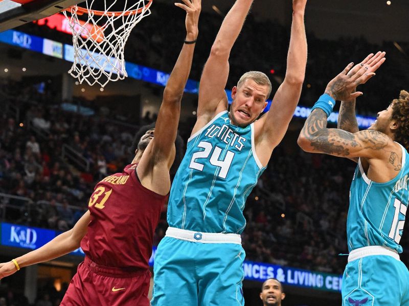 CLEVELAND, OHIO - NOVEMBER 18: Mason Plumlee #24 of the Charlotte Hornets grabs a rebound over Jarrett Allen #31 of the Cleveland Cavaliers during the fourth quarter at Rocket Mortgage Fieldhouse on November 18, 2022 in Cleveland, Ohio. The Cavaliers defeated the Hornets 132-122 in double overtime. NOTE TO USER: User expressly acknowledges and agrees that, by downloading and or using this photograph, User is consenting to the terms and conditions of the Getty Images License Agreement. (Photo by Jason Miller/Getty Images)