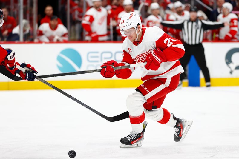 Mar 26, 2024; Washington, District of Columbia, USA; Detroit Red Wings left wing Lucas Raymond (23) battles for the puck against the Washington Capitals during the second period at Capital One Arena. Mandatory Credit: Amber Searls-USA TODAY Sports