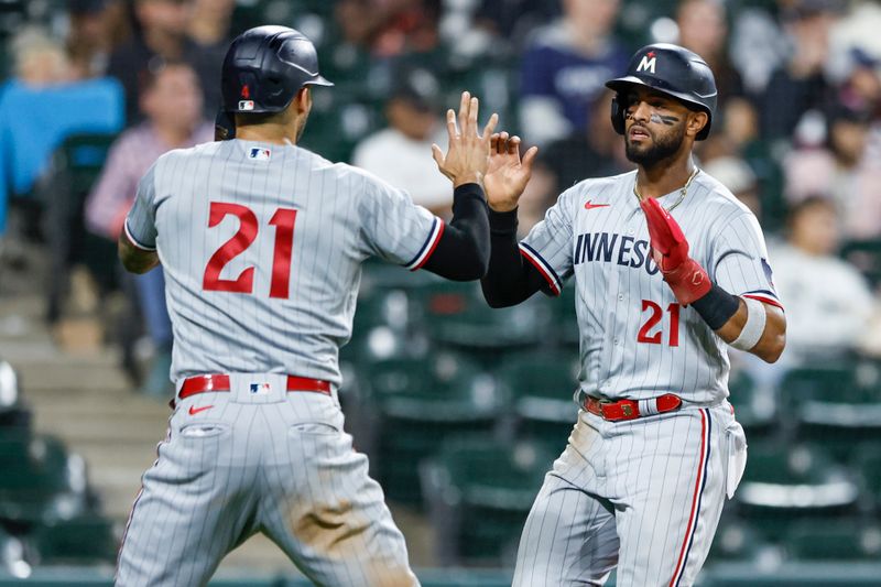 Sep 15, 2023; Chicago, Illinois, USA; Minnesota Twins short stop Carlos Correa (L) celebrates with left fielder Willi Castro (R) after they both scored against the Chicago White Sox during the ninth inning at Guaranteed Rate Field. Mandatory Credit: Kamil Krzaczynski-USA TODAY Sports