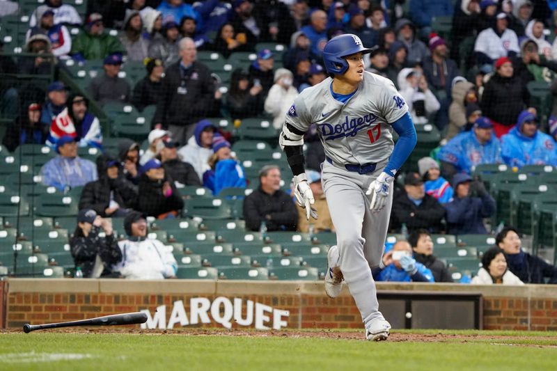 Apr 7, 2024; Chicago, Illinois, USA; Los Angeles Dodgers designated hitter Shohei Ohtani (17) hits a one run double against the Chicago Cubs during the eighth inning at Wrigley Field. Mandatory Credit: David Banks-USA TODAY Sports