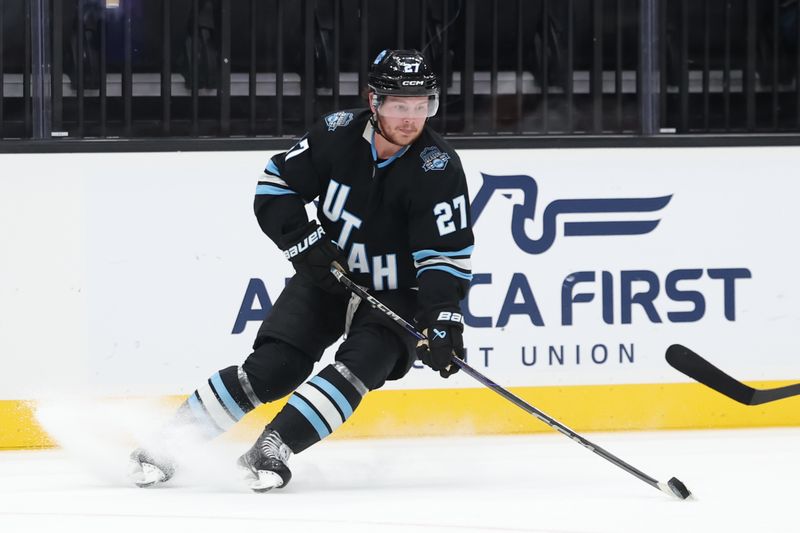 Oct 22, 2024; Salt Lake City, Utah, USA; Utah Hockey Club center Barrett Hayton (27) moves the puck against the Ottawa Senators during the second period at Delta Center. Mandatory Credit: Rob Gray-Imagn Images