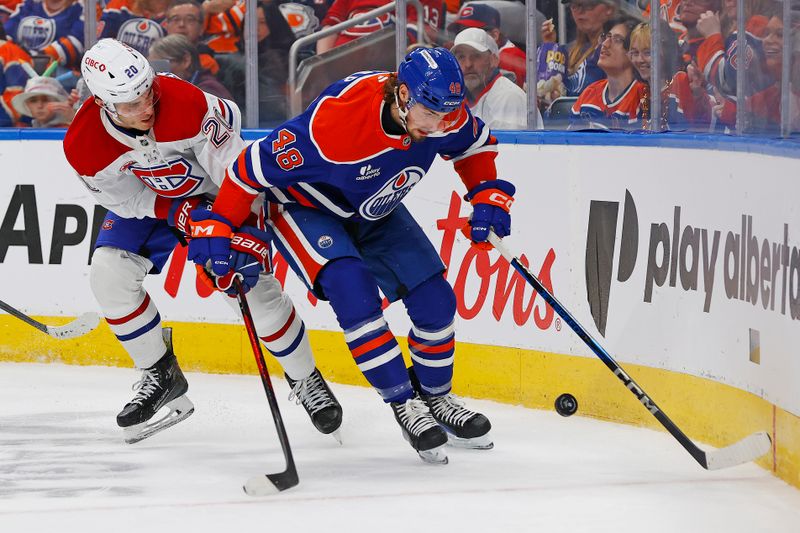 Oct 23, 2025; Edmonton, Alberta, CAN;  Edmonton Oilers forward Noah Philp (48) and Montreal Canadiens forward Juraj Slafkovsky (20) battle along the boards for a loose puck  during the second period at Rogers Place. Mandatory Credit: Perry Nelson-Imagn Images