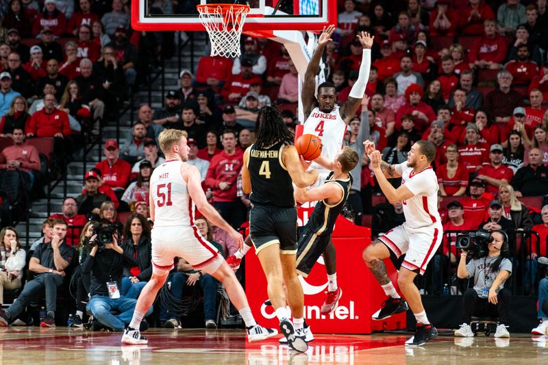 Jan 9, 2024; Lincoln, Nebraska, USA; Purdue Boilermakers guard Fletcher Loyer (2) shoots the ball against Nebraska Cornhuskers forward Juwan Gary (4) and guard C.J. Wilcher (0) during the first half at Pinnacle Bank Arena. Mandatory Credit: Dylan Widger-USA TODAY Sports