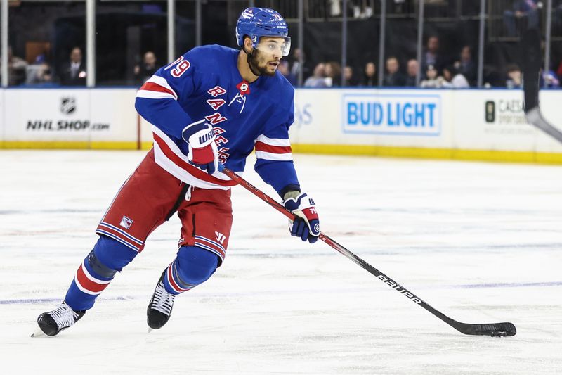 Apr 7, 2024; New York, New York, USA;  New York Rangers defenseman K'Andre Miller (79) controls the puck in the second period against the Montreal Canadiens at Madison Square Garden. Mandatory Credit: Wendell Cruz-USA TODAY Sports