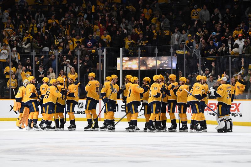 Jan 13, 2024; Nashville, Tennessee, USA; Nashville Predators players celebrate after a win against the New York Islanders at Bridgestone Arena. Mandatory Credit: Christopher Hanewinckel-USA TODAY Sports