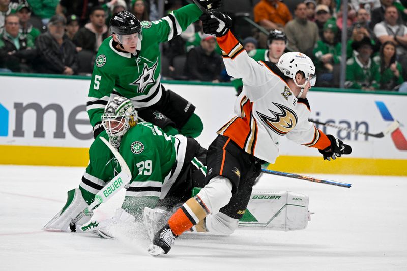 Jan 25, 2024; Dallas, Texas, USA; Dallas Stars defenseman Nils Lundkvist (5) and goaltender Jake Oettinger (29) collide with Anaheim Ducks right wing Frank Vatrano (77) during the third period at the American Airlines Center. Mandatory Credit: Jerome Miron-USA TODAY Sports