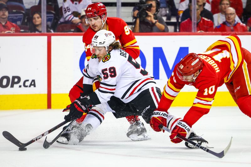 Oct 15, 2024; Calgary, Alberta, CAN; Chicago Blackhawks left wing Tyler Bertuzzi (59) and Calgary Flames center Jonathan Huberdeau (10) battles for the puck during the first period at Scotiabank Saddledome. Mandatory Credit: Sergei Belski-Imagn Images