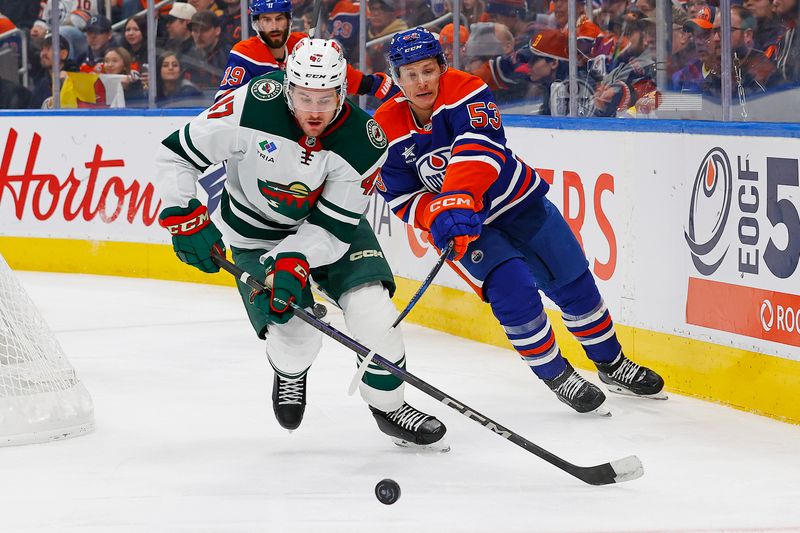 Nov 21, 2024; Edmonton, Alberta, CAN; Minnesota Wild defensemen Declan Chisholm (47) moves the puck in front of Edmonton Oilers forward Jeff Skinner (53) during the second period at Rogers Place. Mandatory Credit: Perry Nelson-Imagn Images