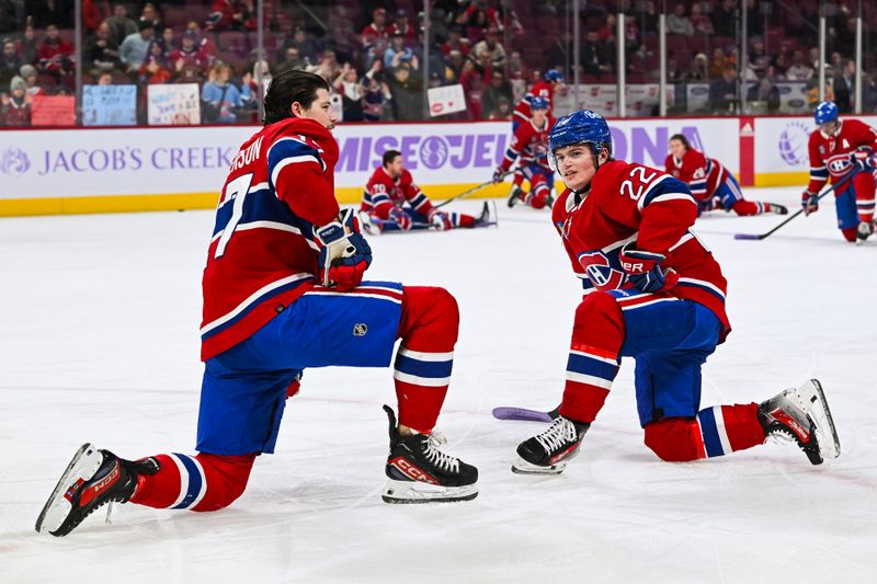 Nov 12, 2023; Montreal, Quebec, CAN; Montreal Canadiens right wing Cole Caufield (22) talks with discussion with right wing Josh Anderson (17) on the ice during warm-up before the game against the Vancouver Canucks at Bell Centre. Mandatory Credit: David Kirouac-USA TODAY Sports