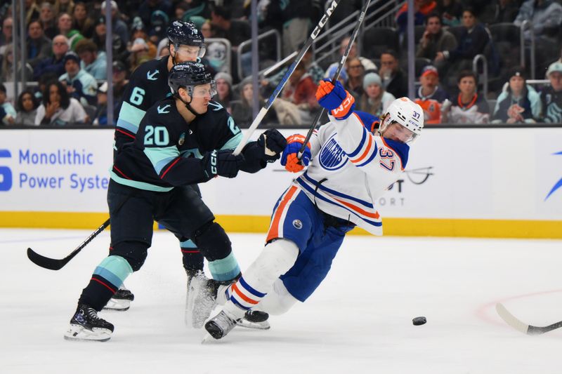 Mar 2, 2024; Seattle, Washington, USA; Seattle Kraken right wing Eeli Tolvanen (20) collides with Edmonton Oilers left wing Warren Foegele (37) during the third period at Climate Pledge Arena. Mandatory Credit: Steven Bisig-USA TODAY Sports