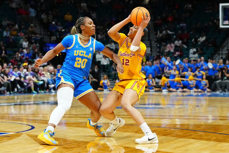 Mar 8, 2024; Las Vegas, NV, USA; USC Trojans guard JuJu Watkins (12) protects the ball from UCLA Bruins guard Charisma Osborne (20) during the third quarter at MGM Grand Garden Arena. Mandatory Credit: Stephen R. Sylvanie-USA TODAY Sports