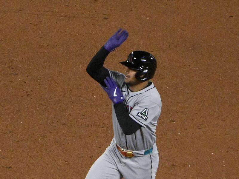 May 23, 2025; St. Louis, Missouri, USA;  Arizona Diamondbacks pinch hitter Gabriel Moreno (14) reacts as he runs the bases after hitting a two run home run against the St. Louis Cardinals during the ninth inning at Busch Stadium. Mandatory Credit: Jeff Curry-Imagn Images