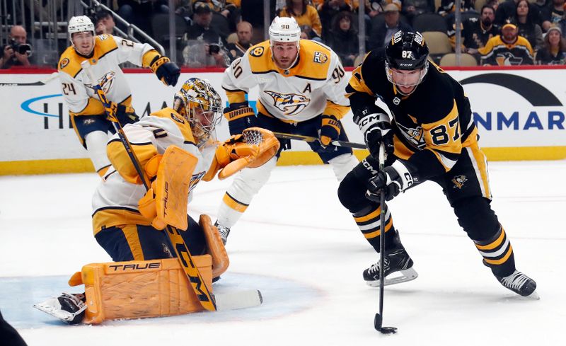 Apr 15, 2024; Pittsburgh, Pennsylvania, USA;  Nashville Predators goaltender Juuse Saros (74) defends the net against Pittsburgh Penguins center Sidney Crosby (87) during the first period at PPG Paints Arena. Mandatory Credit: Charles LeClaire-USA TODAY Sports