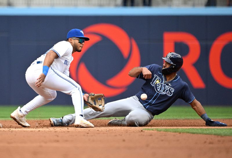 Jul 25, 2024; Toronto, Ontario, CAN;  Tampa Bay Rays third baseman Ahmed Rosario (10) steals second base against Toronto Blue Jays shortstop Leo Jimenez (45) in the second inning at Rogers Centre. Mandatory Credit: Dan Hamilton-USA TODAY Sports