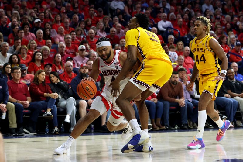 Feb 17, 2024; Tucson, Arizona, USA; Arizona Wildcats guard Kylan Boswell (4) drives to the net against Arizona State Sun Devils center Shawn Phillips Jr. (9) during the second half at McKale Center. Mandatory Credit: Zachary BonDurant-USA TODAY Sports